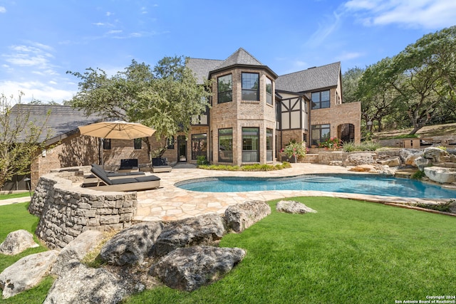 view of swimming pool featuring a yard and a patio