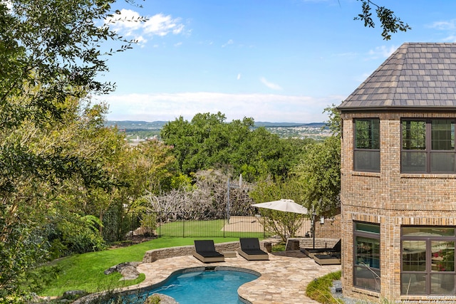 view of pool featuring a lawn and a patio