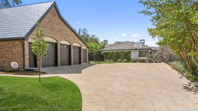 view of side of property with a lawn and a garage