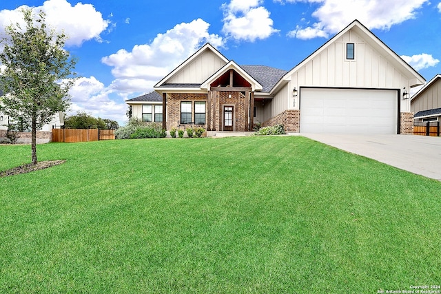 view of front of property featuring a garage and a front lawn