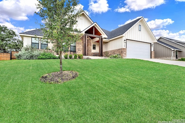 view of front of house featuring a garage and a front lawn