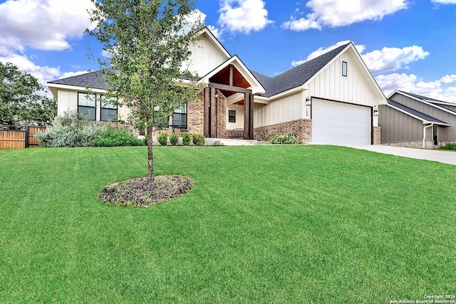 view of front of home with a garage, concrete driveway, fence, a front lawn, and brick siding