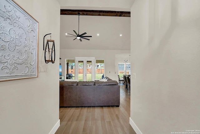 living room with french doors, light wood-style flooring, high vaulted ceiling, beamed ceiling, and baseboards