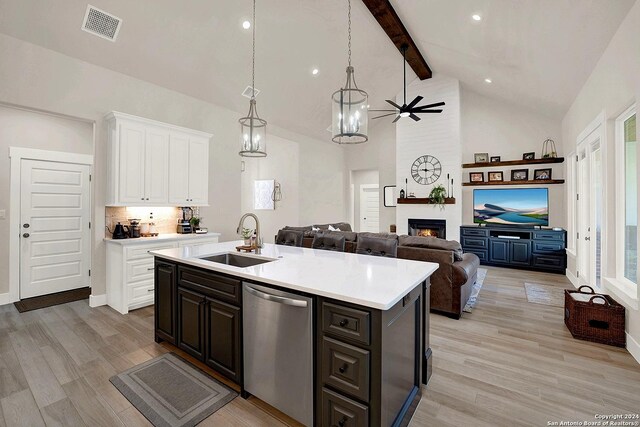 kitchen with appliances with stainless steel finishes, light stone counters, a chandelier, and sink