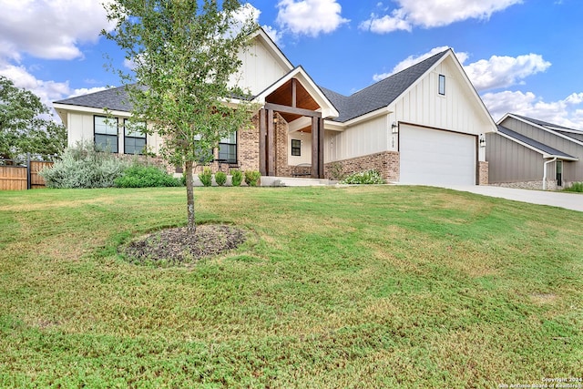 view of front facade featuring an attached garage, brick siding, fence, driveway, and a front lawn