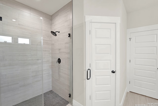 bathroom with a shower with shower door