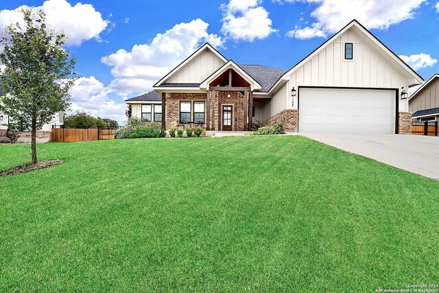 view of front of property featuring a garage and a front lawn