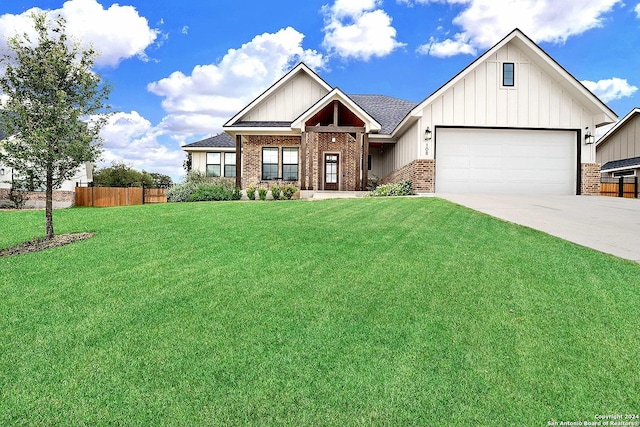 view of front of house featuring concrete driveway, brick siding, fence, and a front lawn