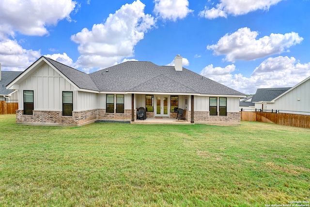 back of property featuring a fenced backyard, brick siding, and a lawn