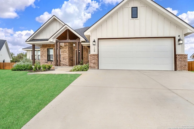 view of front of property featuring a garage, board and batten siding, and brick siding