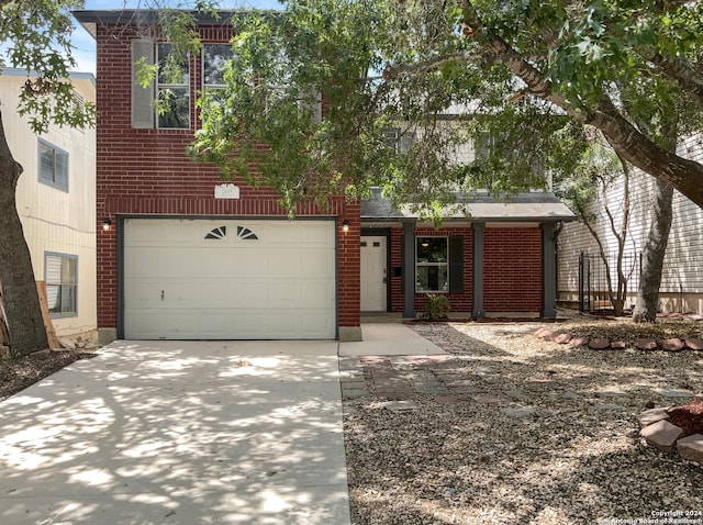 view of front facade with driveway and brick siding