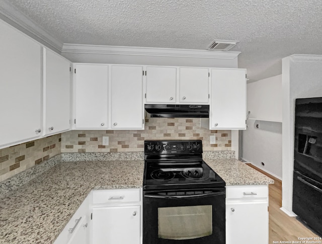 kitchen with white cabinets, light hardwood / wood-style flooring, light stone counters, black appliances, and tasteful backsplash