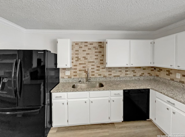 kitchen with black appliances, decorative backsplash, light hardwood / wood-style floors, and white cabinetry