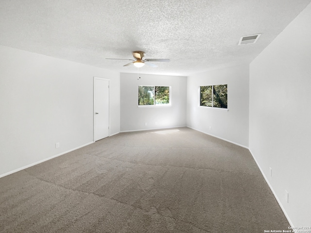 unfurnished room featuring ceiling fan, a textured ceiling, and carpet floors