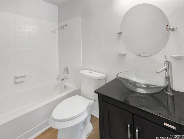 full bathroom featuring vanity, toilet, tiled shower / bath combo, and wood-type flooring