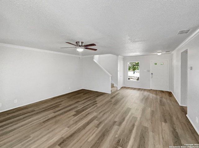 unfurnished living room featuring crown molding, a textured ceiling, hardwood / wood-style flooring, and ceiling fan