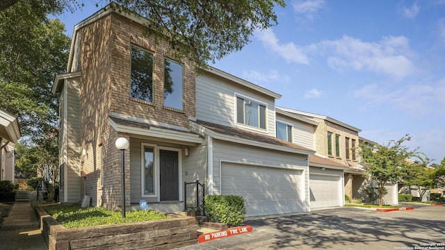 view of property featuring aphalt driveway and an attached garage