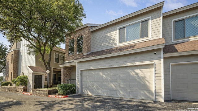 townhome / multi-family property with brick siding and an attached garage