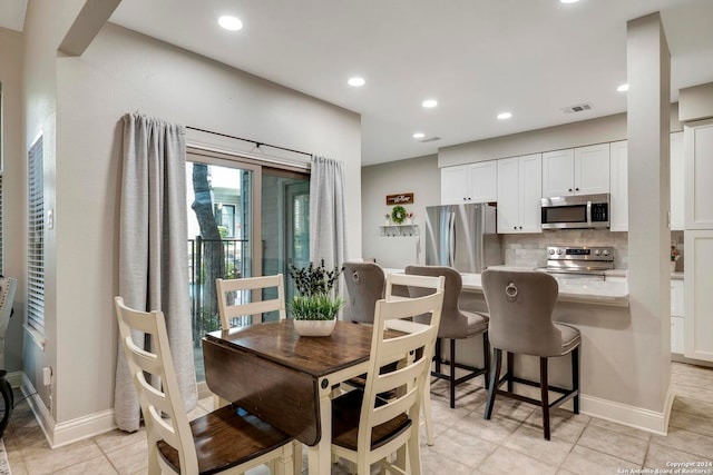 dining area featuring light tile patterned floors