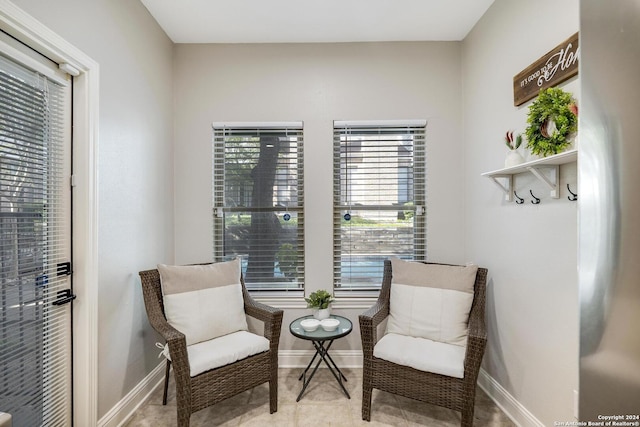 living area featuring tile patterned flooring and baseboards