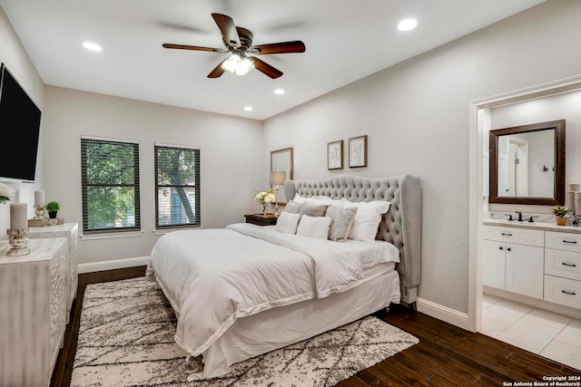 bedroom with ceiling fan, sink, wood-type flooring, and ensuite bathroom