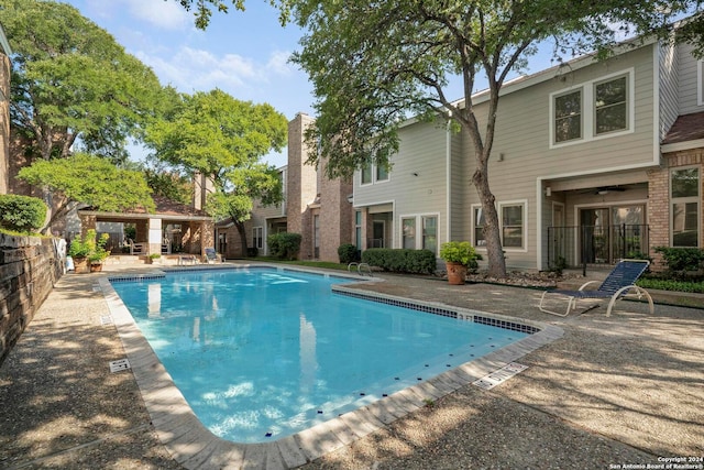 view of pool featuring ceiling fan and a patio