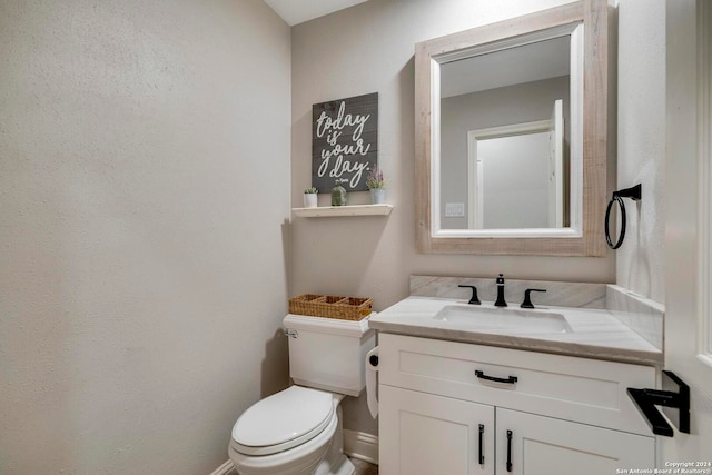 bathroom featuring toilet and vanity