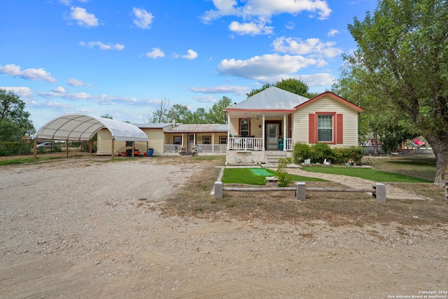 view of front of property with covered porch, a front yard, and a carport