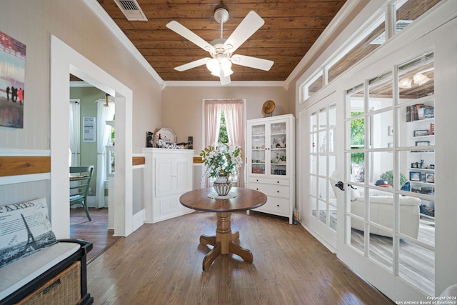 interior space featuring ceiling fan, wooden ceiling, wood-type flooring, and ornamental molding