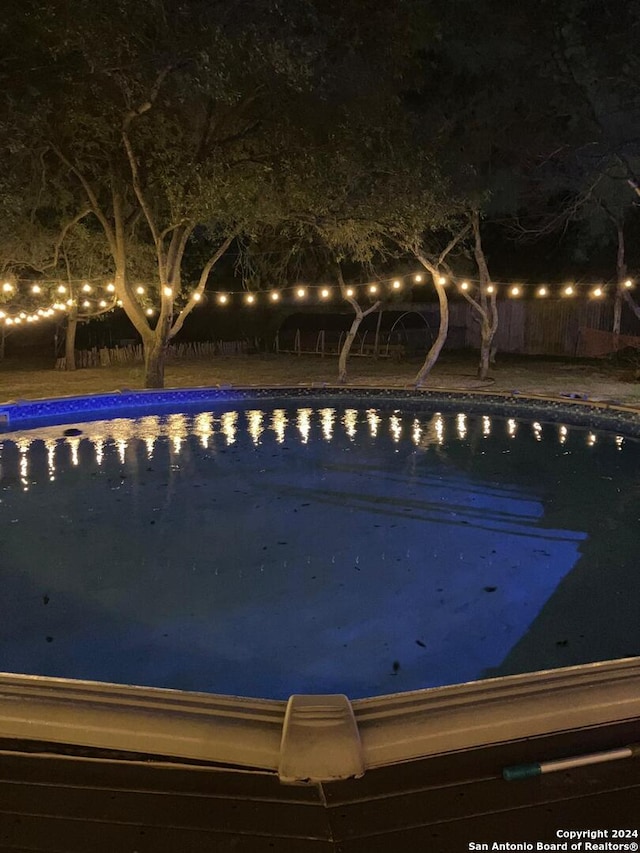 view of pool at night