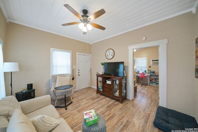 living room featuring ornamental molding, light wood-type flooring, and a wealth of natural light