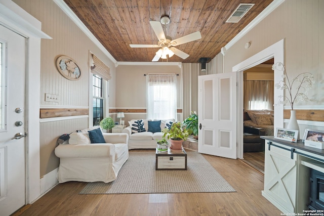 interior space with ornamental molding, wooden ceiling, light wood-type flooring, and ceiling fan