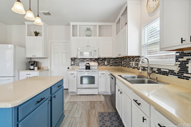 kitchen with white appliances, backsplash, decorative light fixtures, sink, and blue cabinets