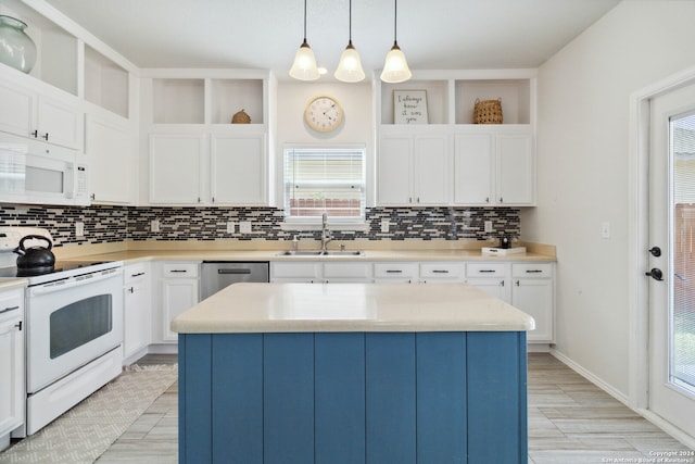 kitchen with a kitchen island, pendant lighting, sink, and white appliances