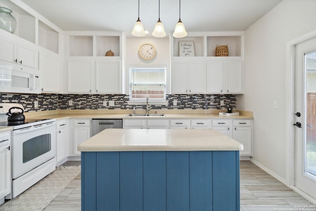 kitchen featuring white appliances, a sink, white cabinets, a center island, and open shelves