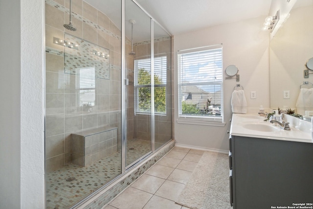 bathroom with tile patterned flooring, an enclosed shower, and vanity