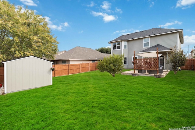 rear view of property featuring a yard, a shed, and a patio