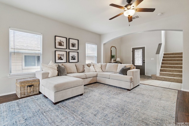 living room with a healthy amount of sunlight, ceiling fan, and light hardwood / wood-style flooring