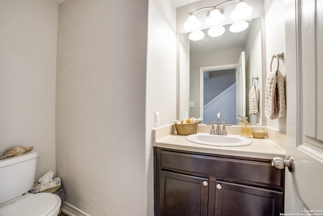 bathroom with toilet and vanity