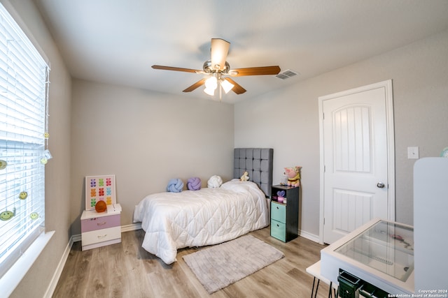 bedroom with light hardwood / wood-style flooring and ceiling fan