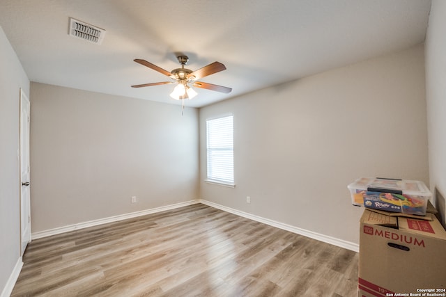 empty room featuring ceiling fan and light hardwood / wood-style floors