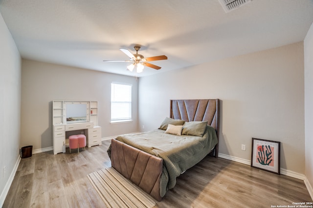 bedroom with ceiling fan and light hardwood / wood-style floors