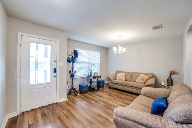 living room featuring light hardwood / wood-style flooring and a chandelier