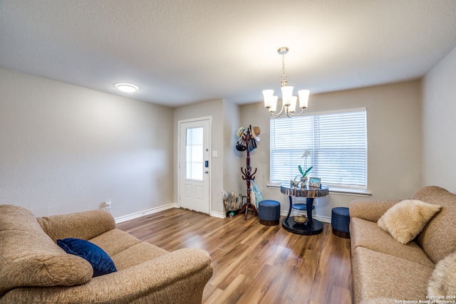 living room with a notable chandelier and hardwood / wood-style floors