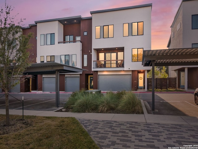 view of front of property with a balcony and a garage