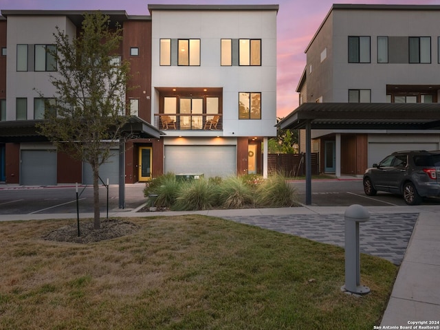 contemporary house featuring a garage and a lawn