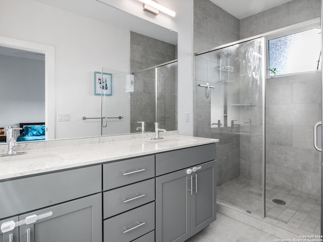 bathroom with tile patterned floors, an enclosed shower, and vanity