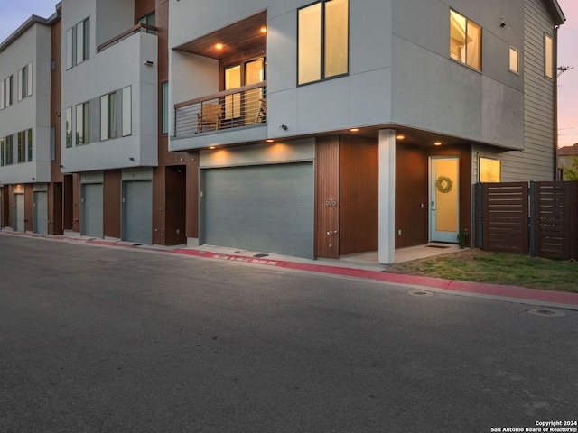 view of front of house with a balcony and a garage