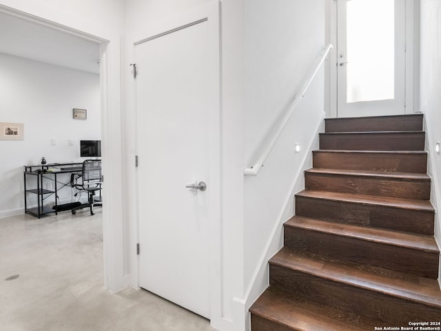 stairway with concrete flooring