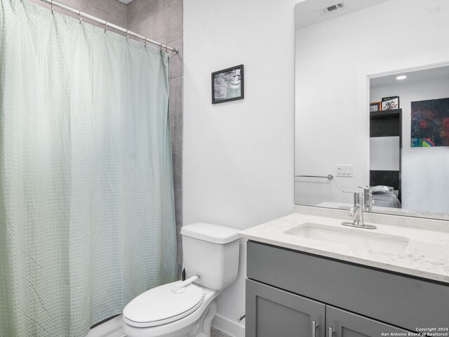 bathroom featuring vanity, toilet, and a shower with curtain